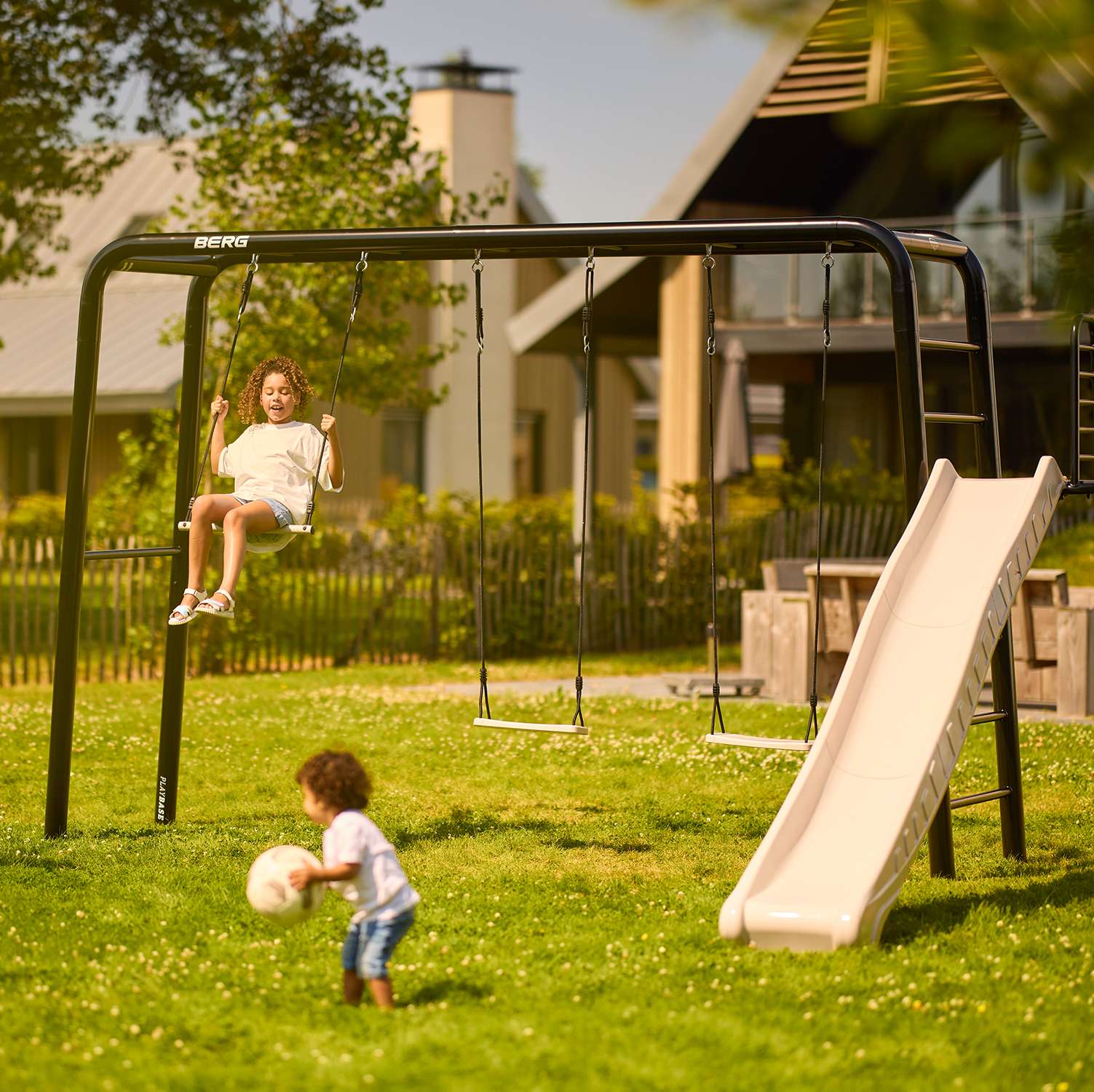 Swings on a BERG PlayBase frame in an Irish garden